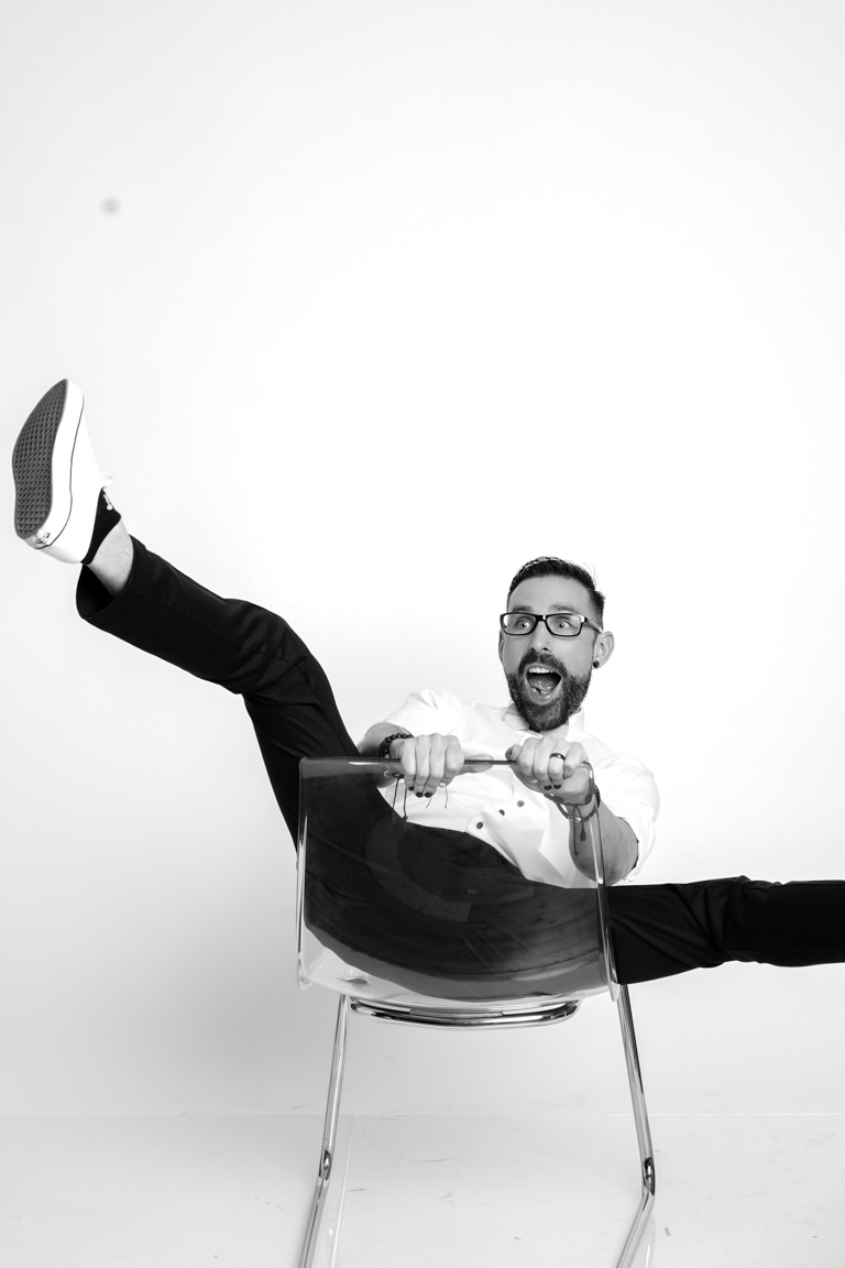 man falling out of chair while doing self portrait