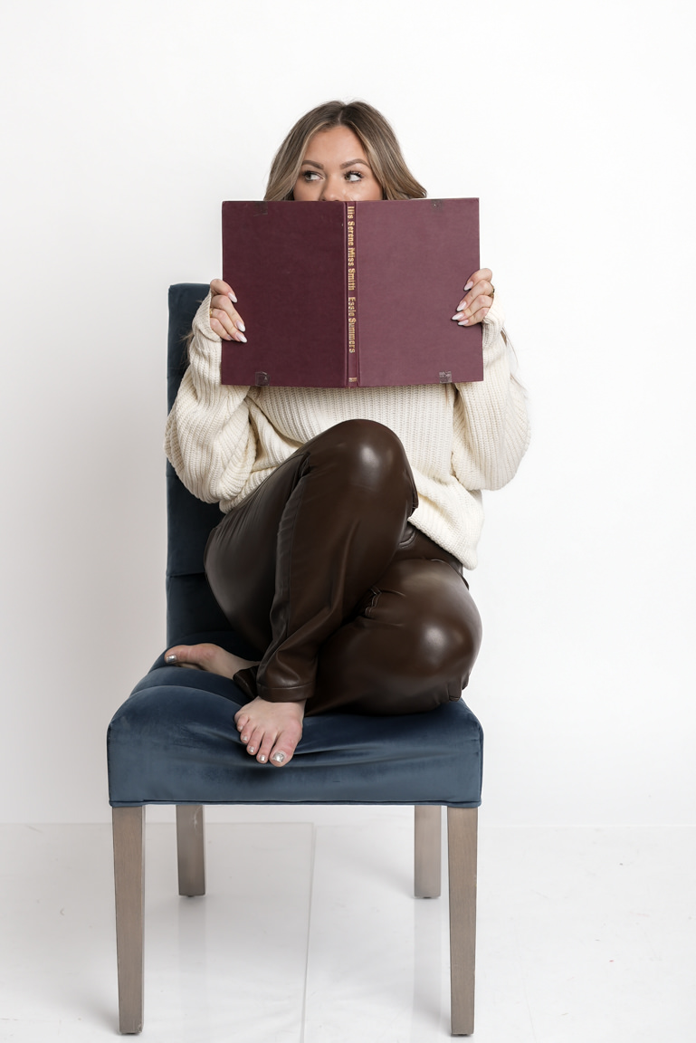 woman sitting on chair covering her face with book self portraits
