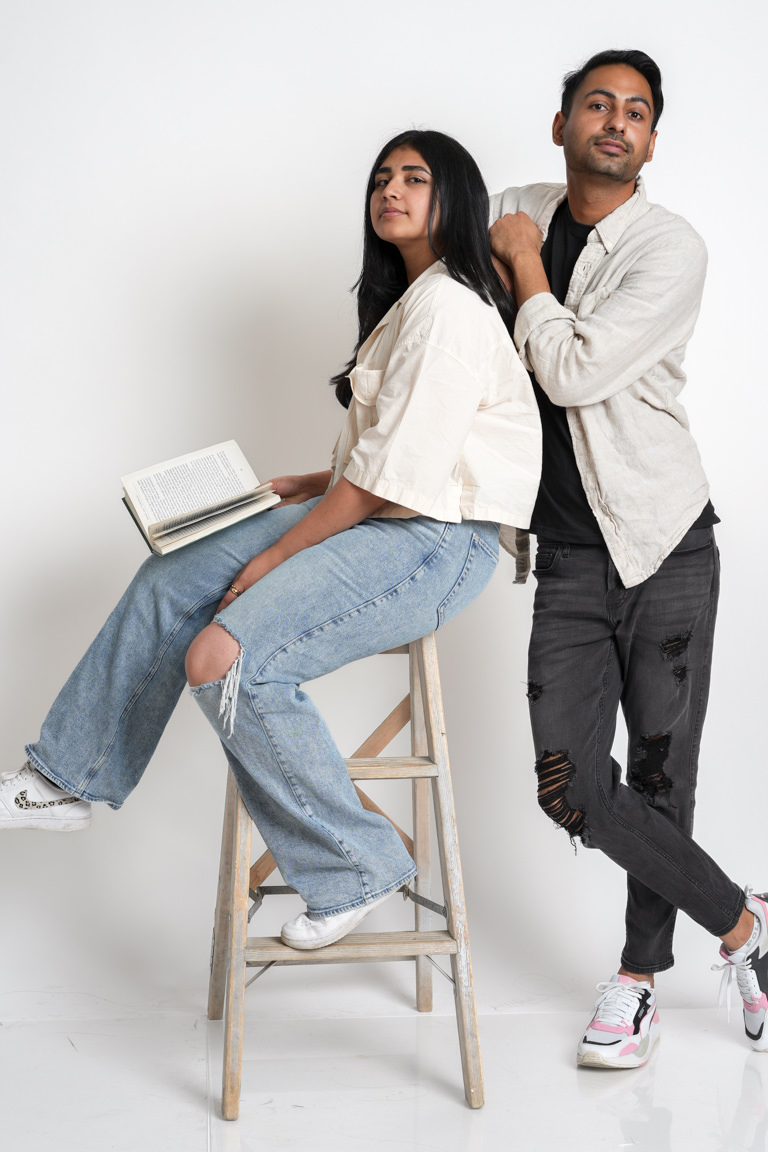 couple doing self portraits with book and ladder